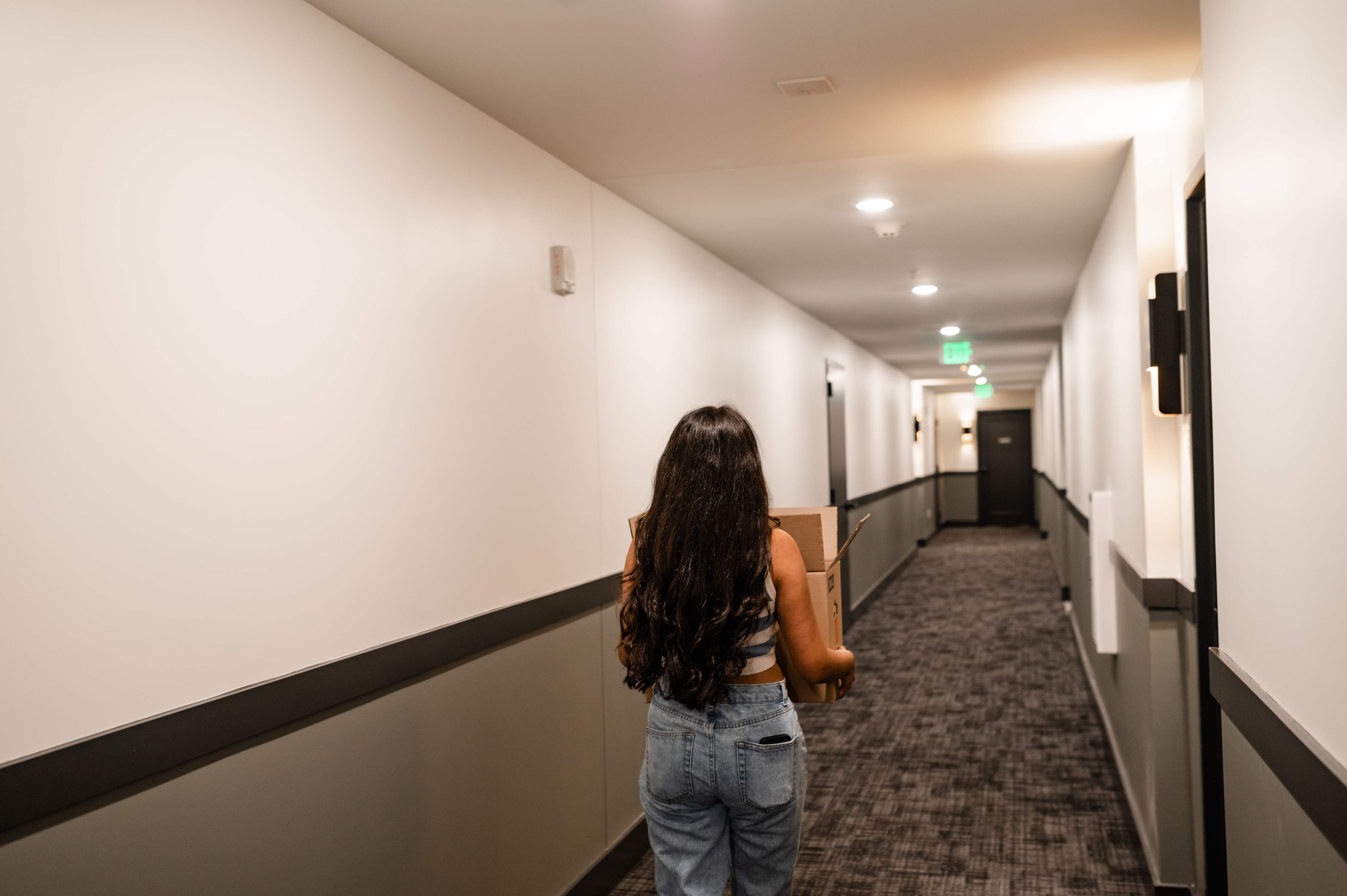 girl with package walking down the hallway