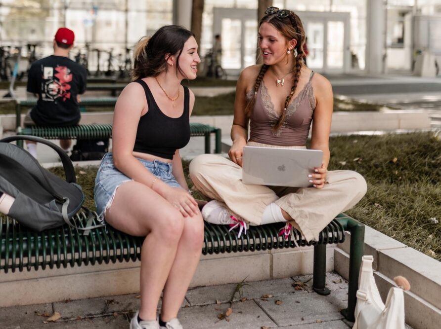 two girls talking over homework on campus at georgia tech near rambler atlanta